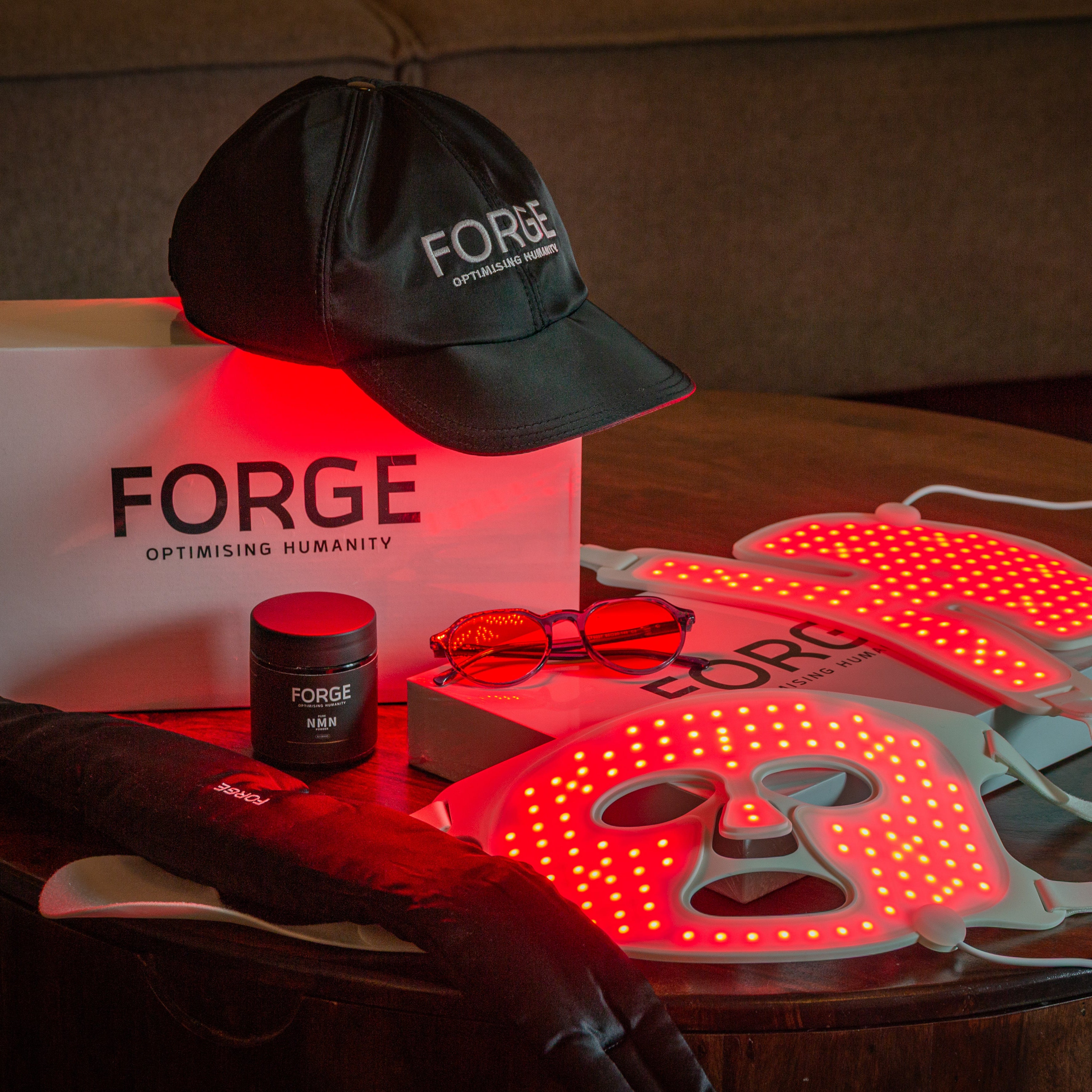 Forge products including a cap, box, and LED devices on a table.