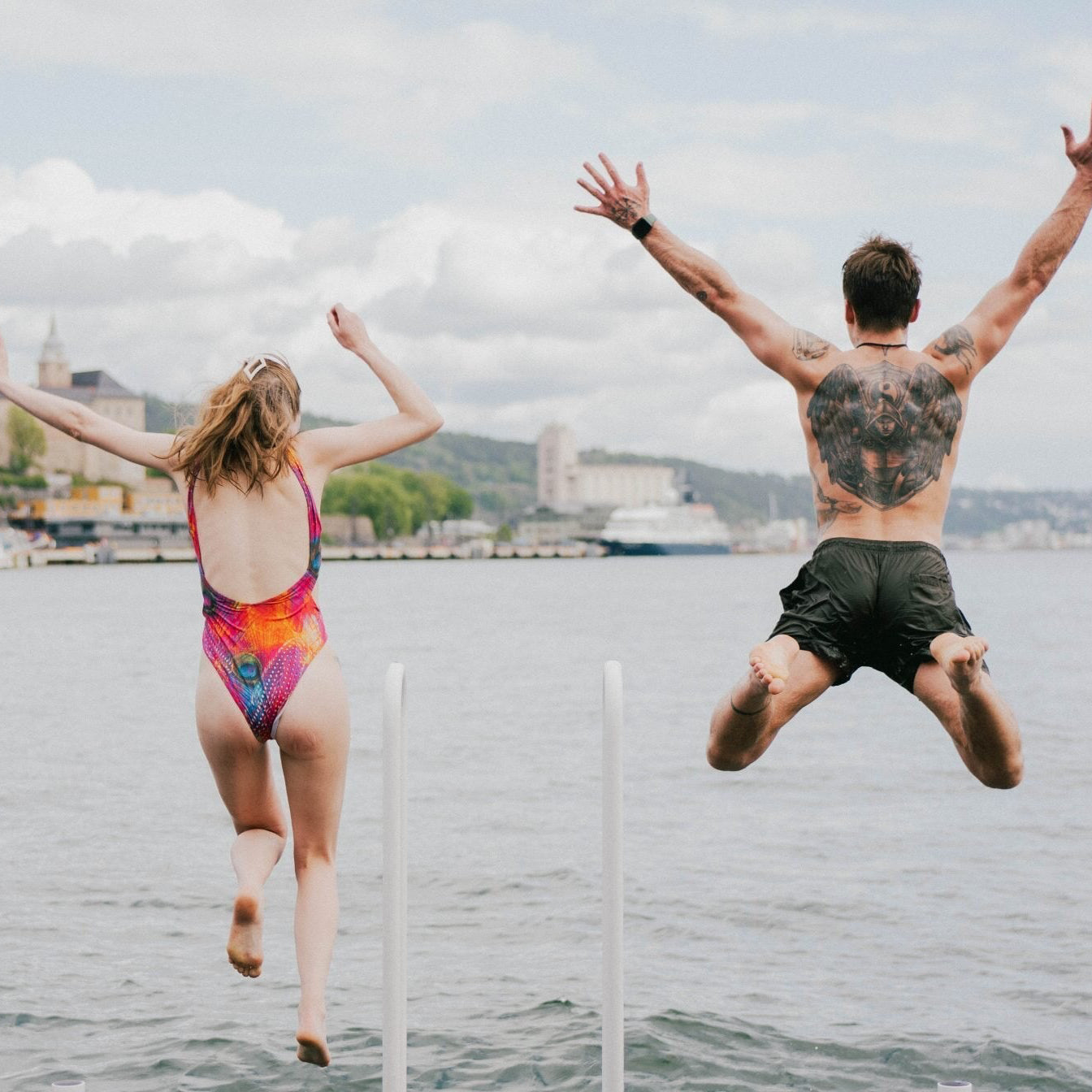 Two people jumping into Oslofjord during Forge Oslo Longevity Community Meet up - Blue Light Blockers, Sauna Tents, NMN powder and Red Light and Infrared Therapy.